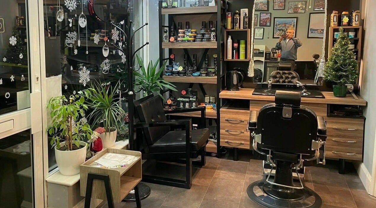 Interior of Dads&Lads Barbershop in Heswall, England, featuring styling chairs and festive decor.