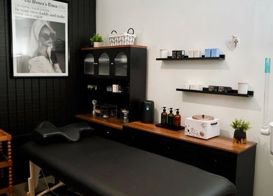 Relaxing treatment room at Kendra in Downey, California, US, featuring a massage table and serene decor.