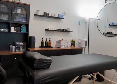 Cozy treatment room at Pulchrify by Kendra, Downey, California, US, featuring a massage table and wellness products.