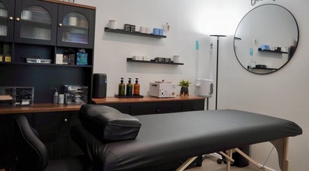 Cozy treatment room at Pulchrify by Kendra, Downey, California, US, featuring a massage table and wellness products.