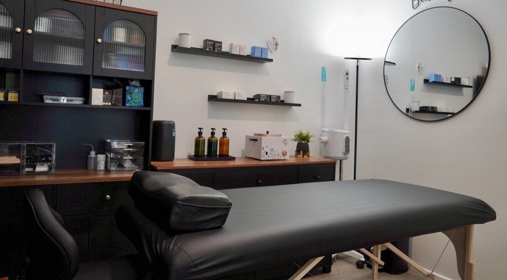 Cozy treatment room at Pulchrify by Kendra, Downey, California, US, featuring a massage table and wellness products.