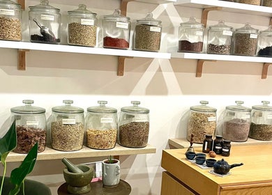 A variety of herbs in glass jars at Magic Turtle Clinic, Avalon Beach, New South Wales, AU, showcasing natural wellness.