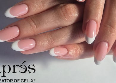 Elegant French tip nails at Shreen Gayle Works, Wallington, England, GB, showcasing flawless pink and white design.