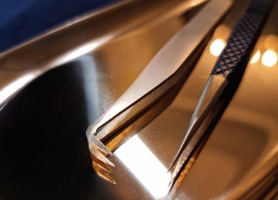 Close-up of premium golden tweezers at Beauty Lash Bar, Bournemouth, England, GB, showcasing luxury tools.