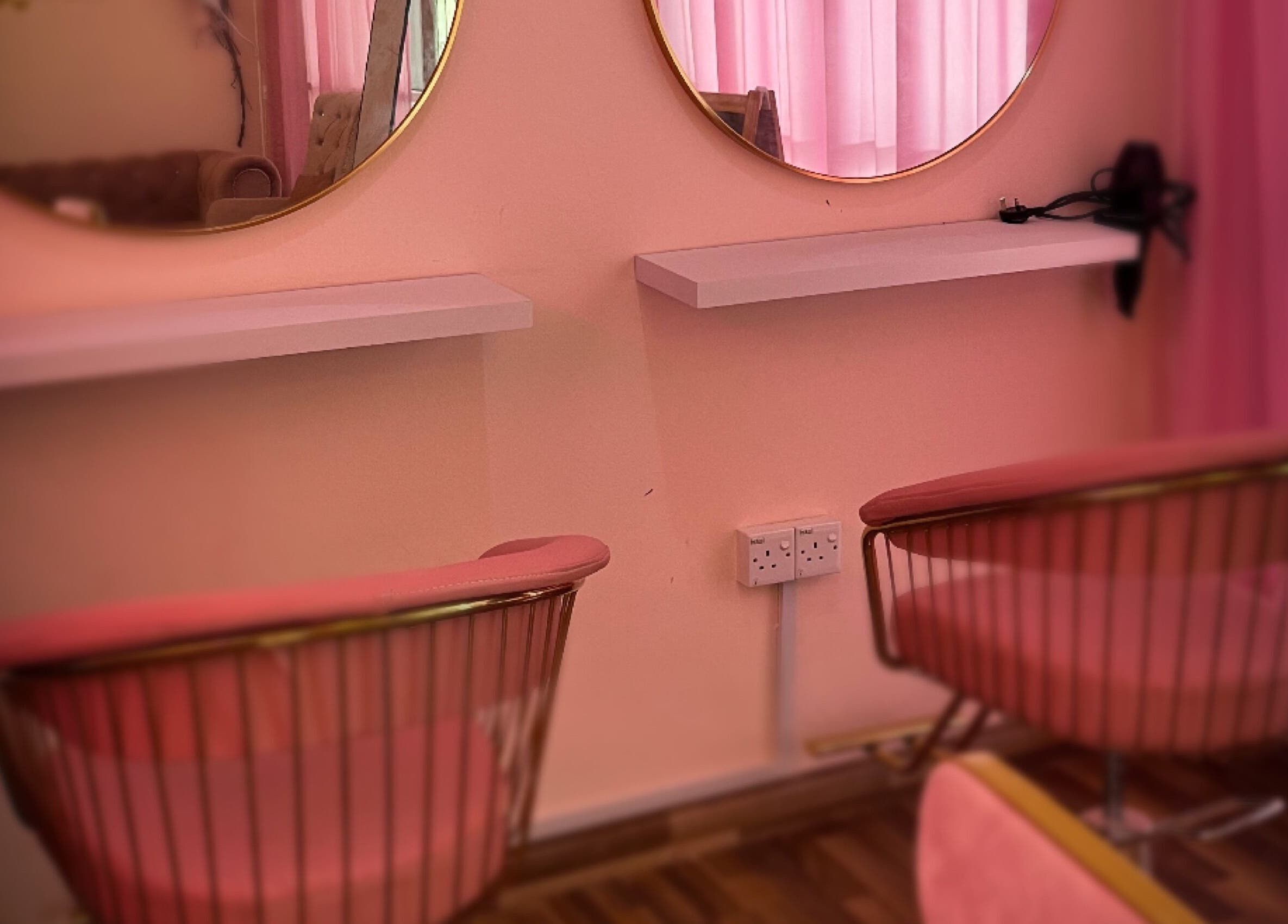 Stylish salon seating at Eyelash by Tasha in Petaling Jaya, Selangor, MY, featuring pink chairs and mirrors.