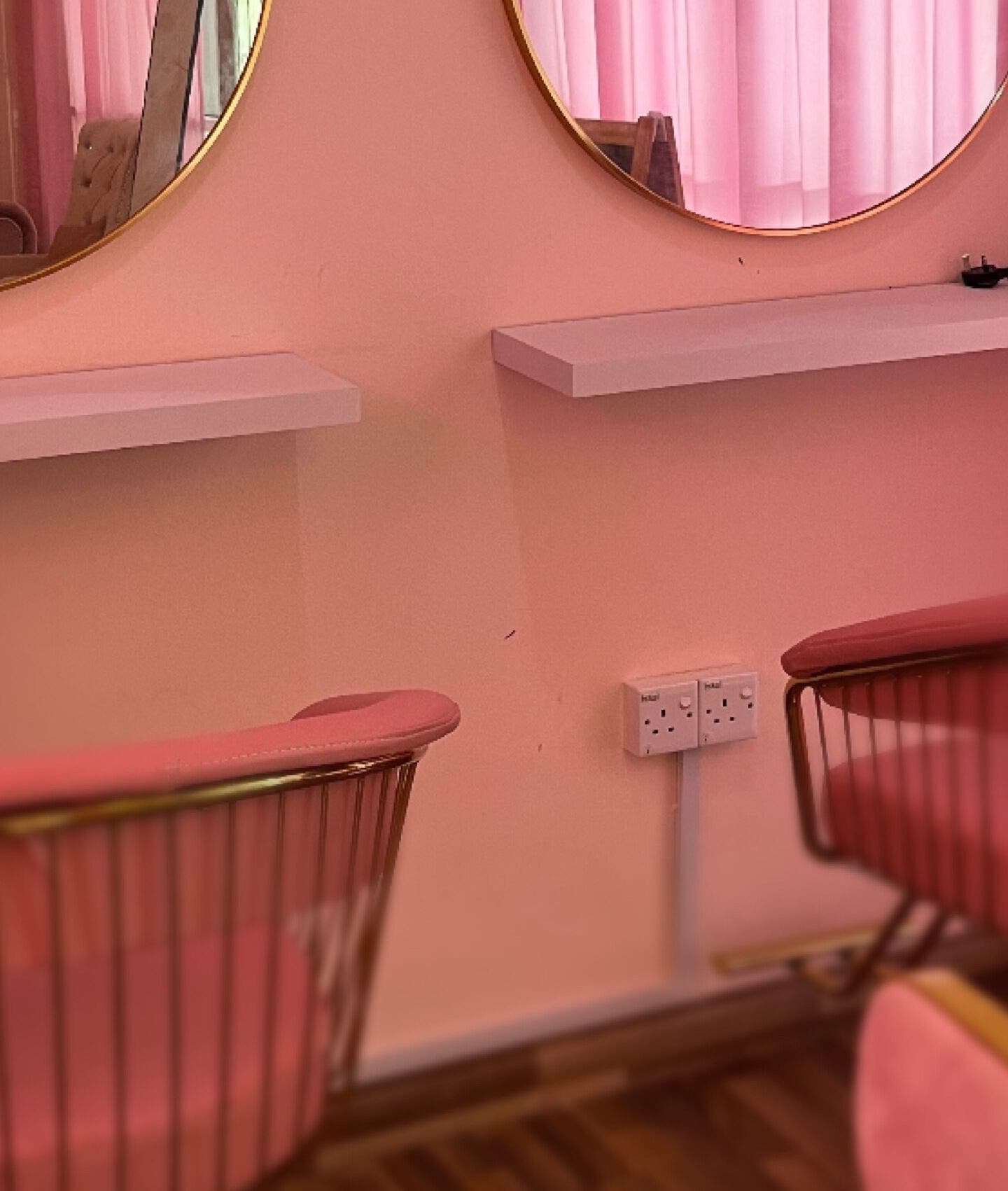Stylish salon seating at Eyelash by Tasha in Petaling Jaya, Selangor, MY, featuring pink chairs and mirrors.