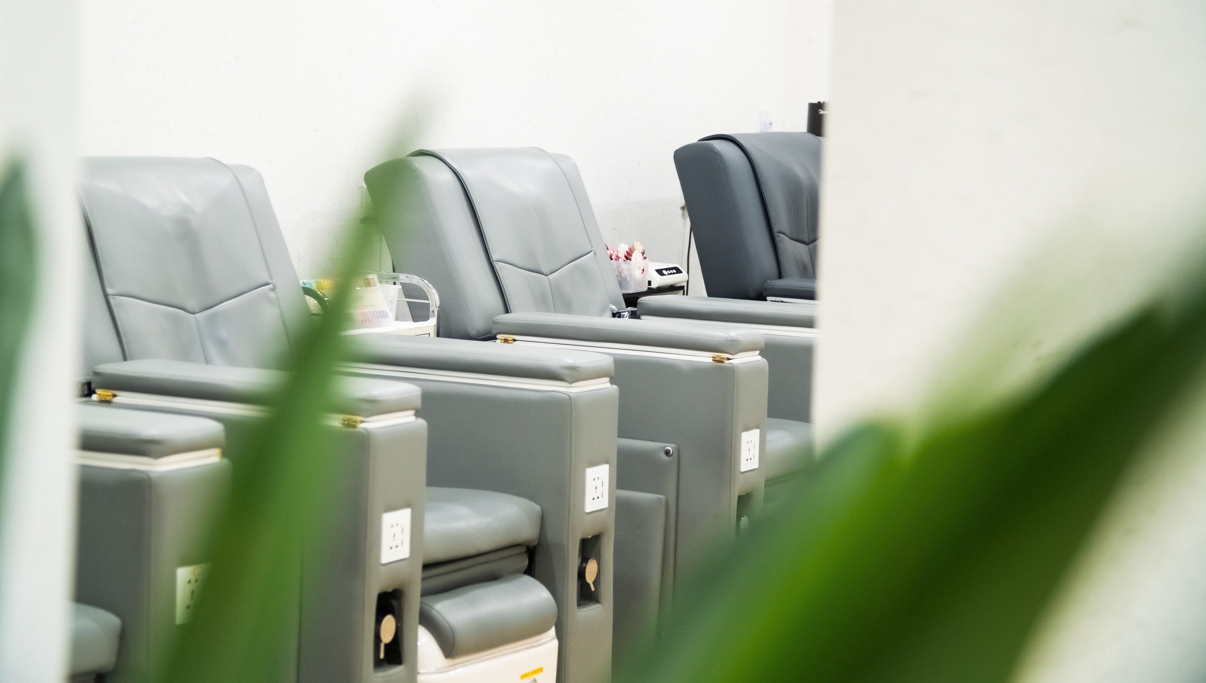 Comfortable grey salon chairs at Lush & Glow in Singapore, Singapore, SG, ready for clients' relaxation.