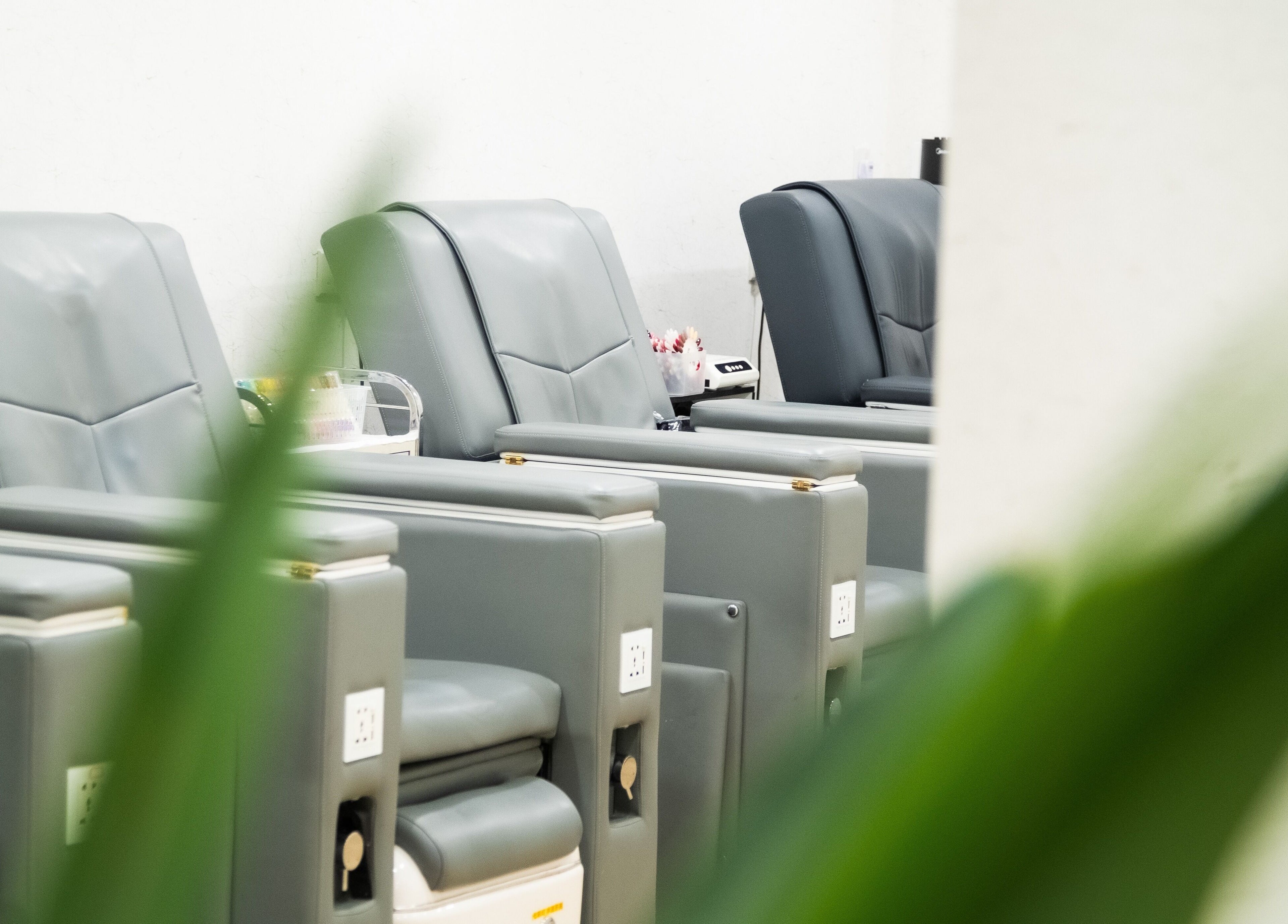 Comfortable grey salon chairs at Lush & Glow in Singapore, Singapore, SG, ready for clients' relaxation.
