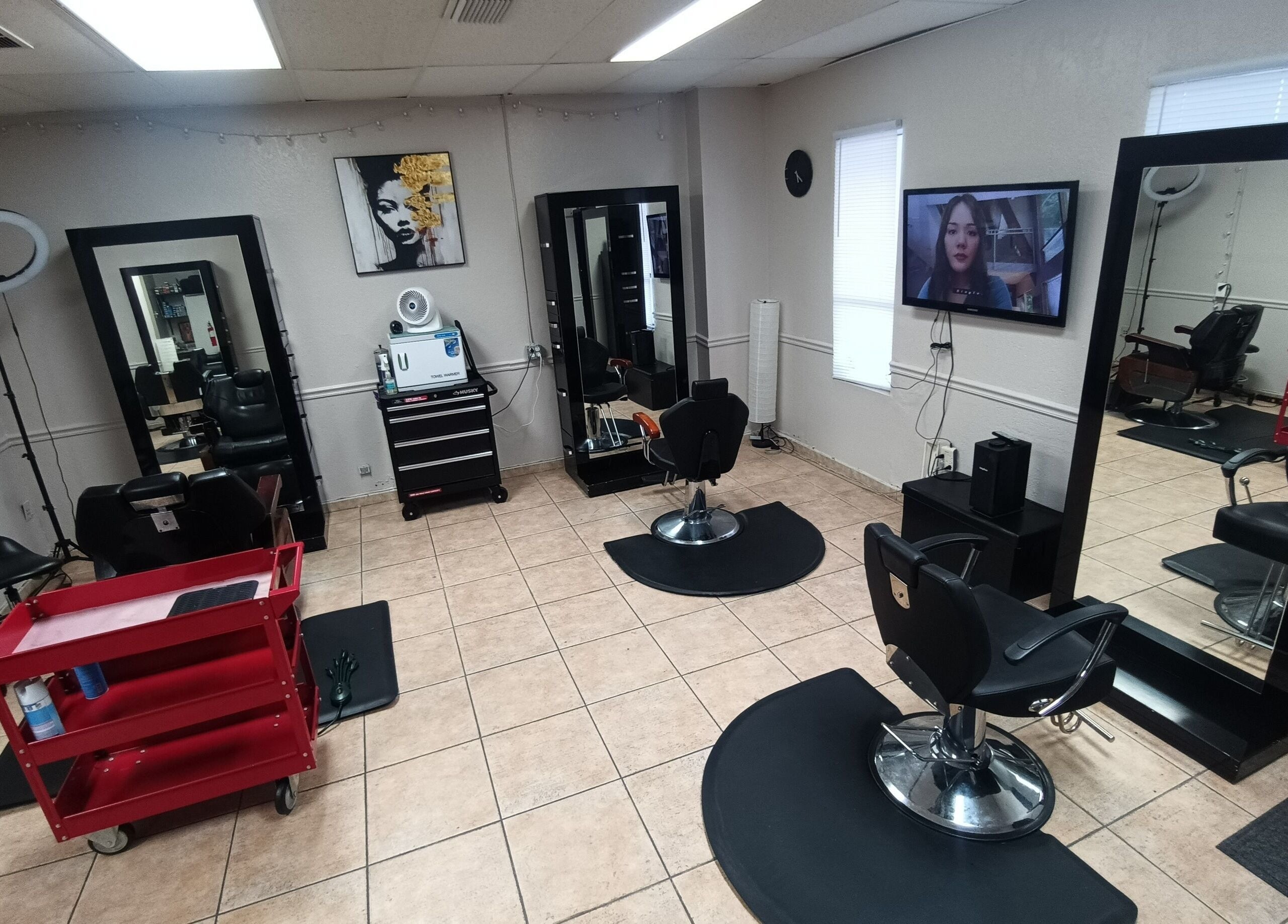Interior of AJ Styles You Salon in Orlando, Florida, US featuring modern styling chairs and large mirrors.