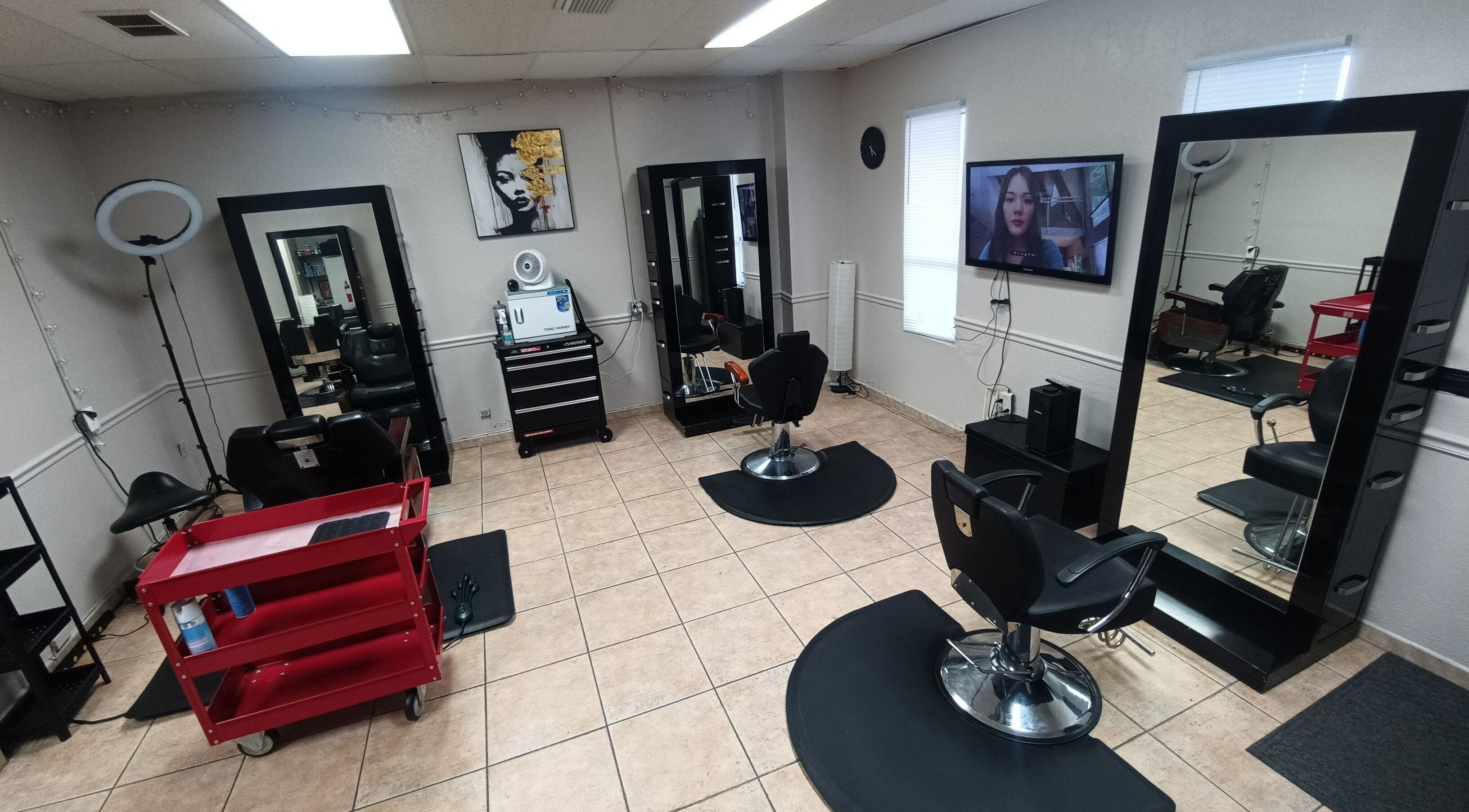 Interior of AJ Styles You Salon in Orlando, Florida, US featuring modern styling chairs and large mirrors.