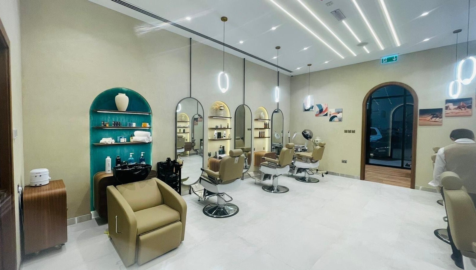A modern salon interior at Zaks and Sons Salon and Spa in Manama, Capital Governorate, BH with elegant styling chairs.