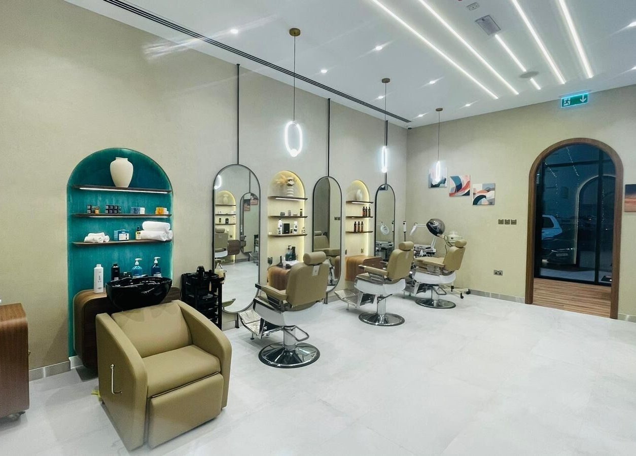 A modern salon interior at Zaks and Sons Salon and Spa in Manama, Capital Governorate, BH with elegant styling chairs.