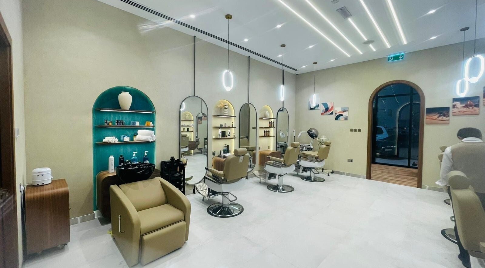 A modern salon interior at Zaks and Sons Salon and Spa in Manama, Capital Governorate, BH with elegant styling chairs.