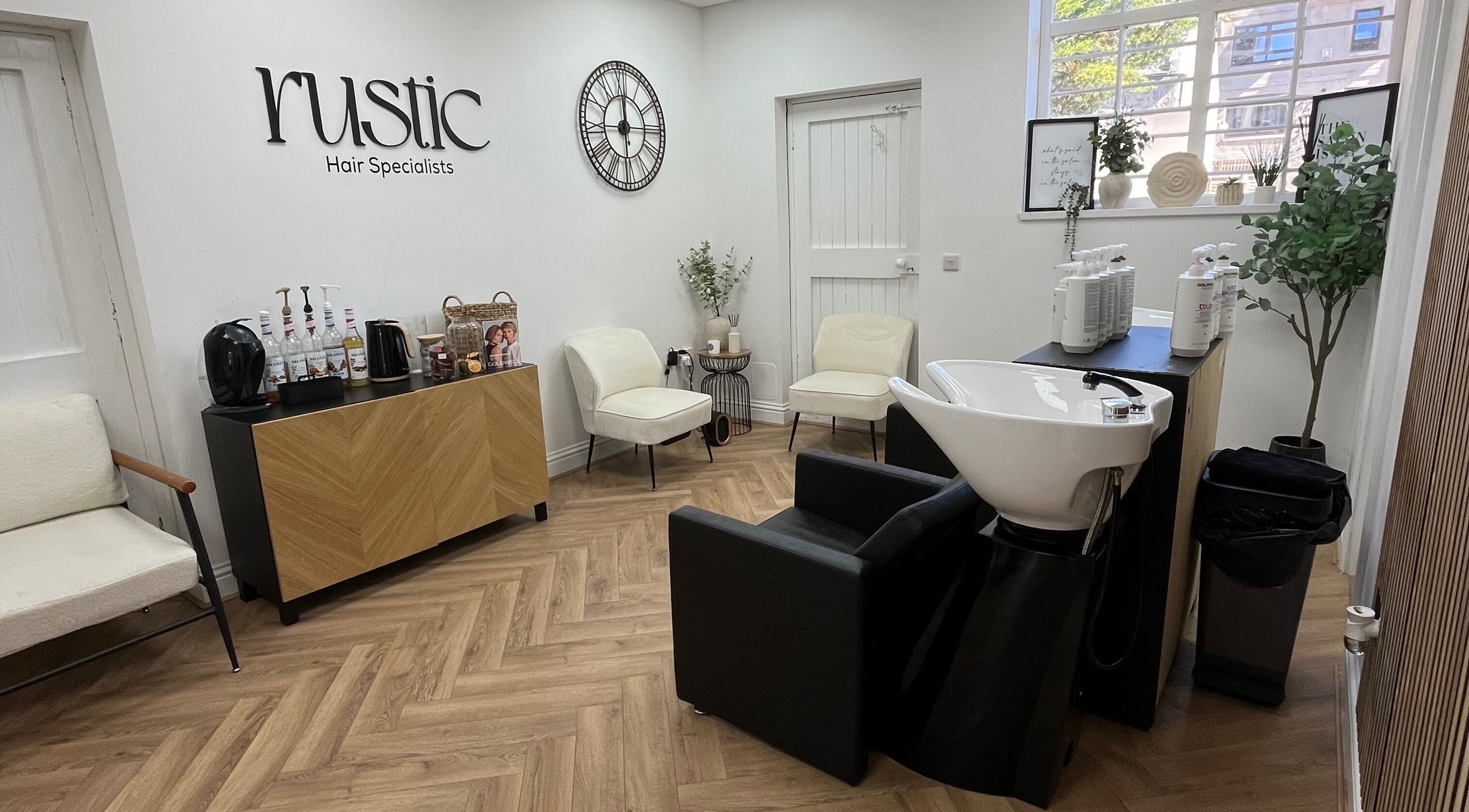 Modern interior of Kate Stephen Hair in Aberdeen, Scotland, GB with elegant seating and styling station.