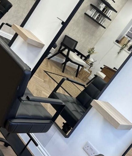 Modern salon interior at Kate Stephen Hair in Aberdeen, Scotland, GB showcasing elegant styling chairs and mirrors.