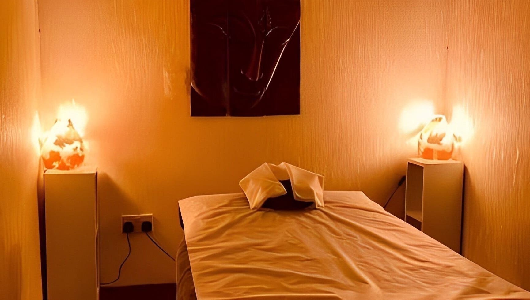 Relaxing massage room at Golden Desert Spa For Men, Abu Dhabi, featuring cozy lighting and serene decor.