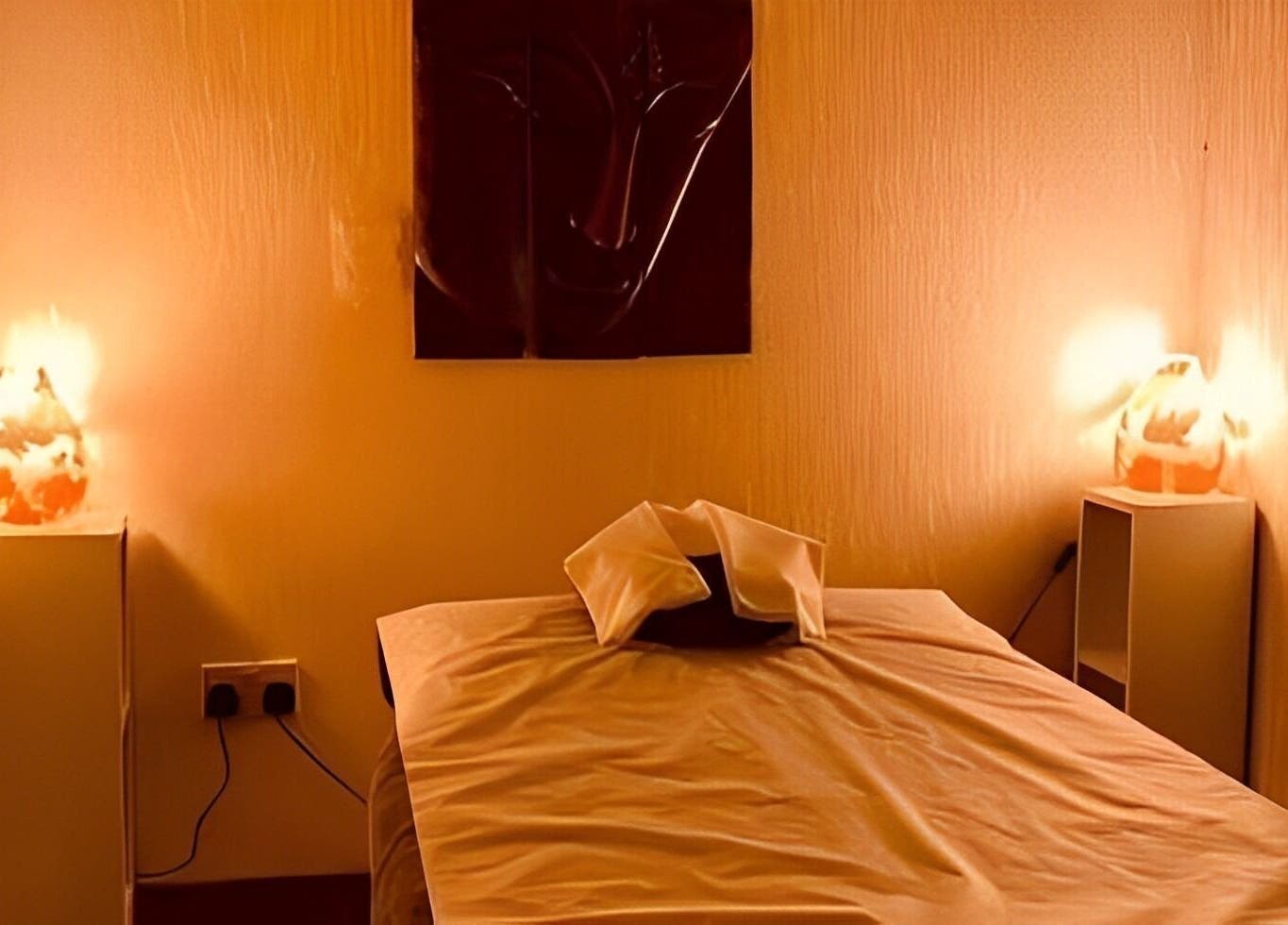 Relaxing massage room at Golden Desert Spa For Men, Abu Dhabi, featuring cozy lighting and serene decor.