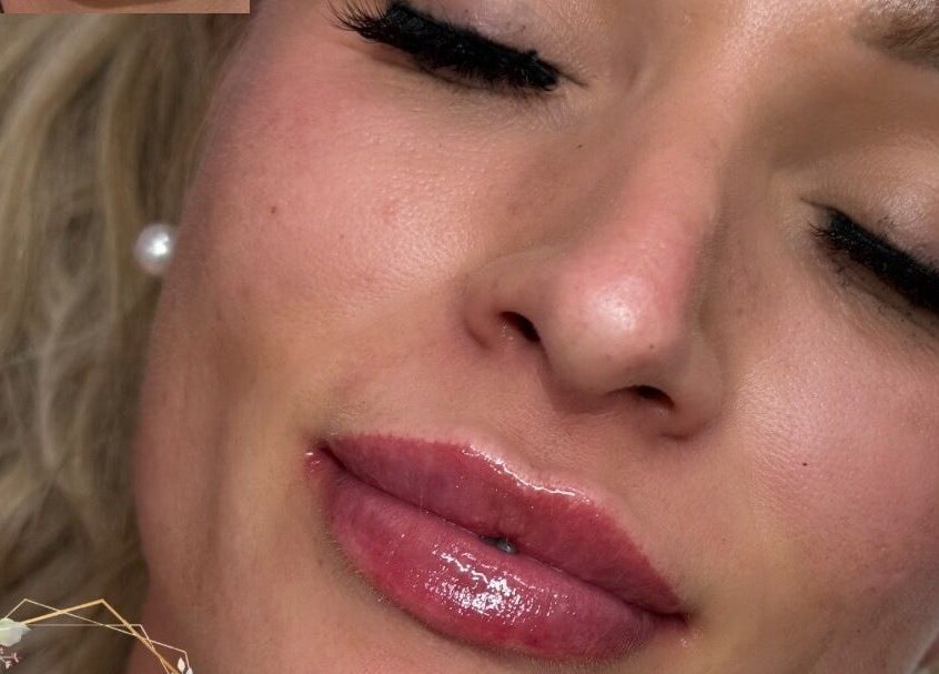 Close-up of a woman with glossy lips and flawless skin at Get Glam Hair & Aesthetics, Oldland Common, England, GB.