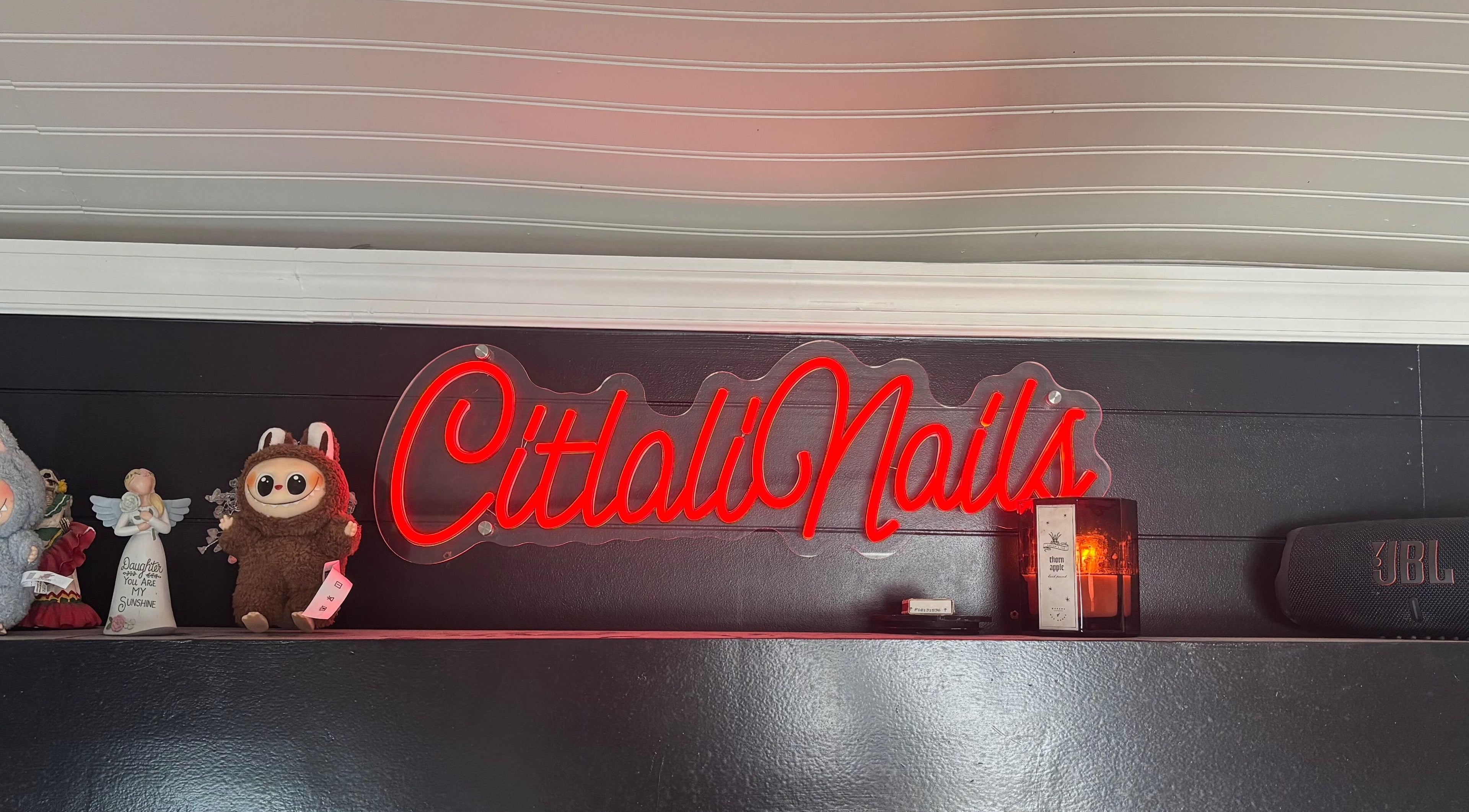 Citlalinails neon sign with decor on shelf in Brick Township, New Jersey, US.