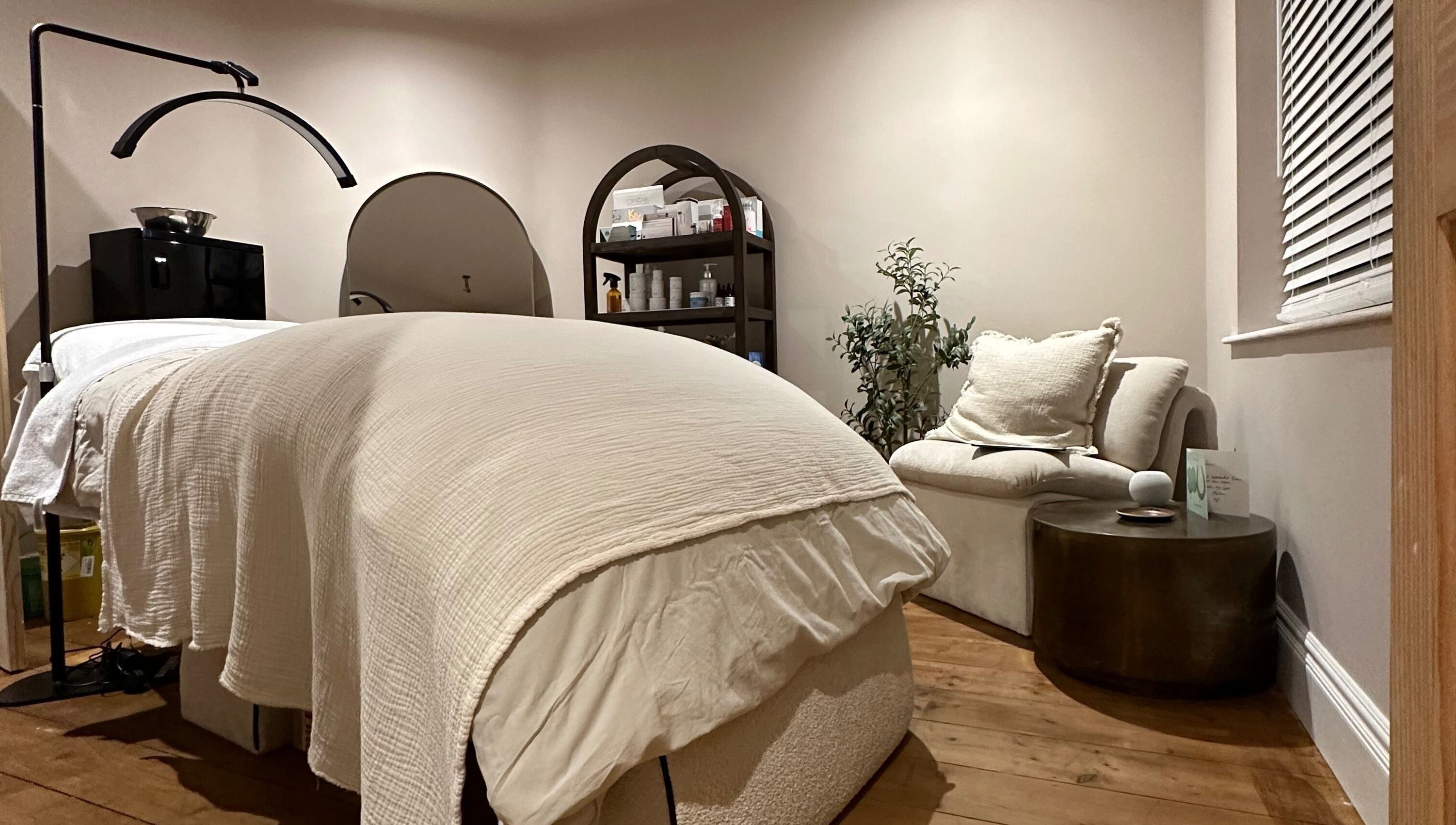 Calming treatment room at Victoria Mancini Skin, Wellington, England, GB with soothing decor and a cozy bed.