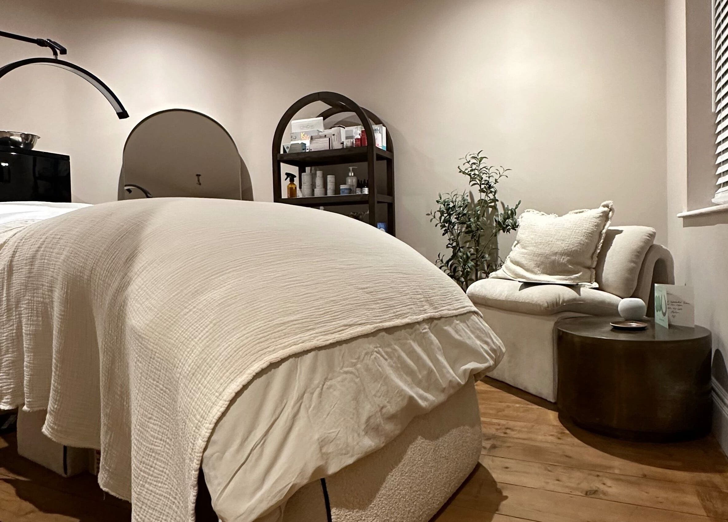 Calming treatment room at Victoria Mancini Skin, Wellington, England, GB with soothing decor and a cozy bed.
