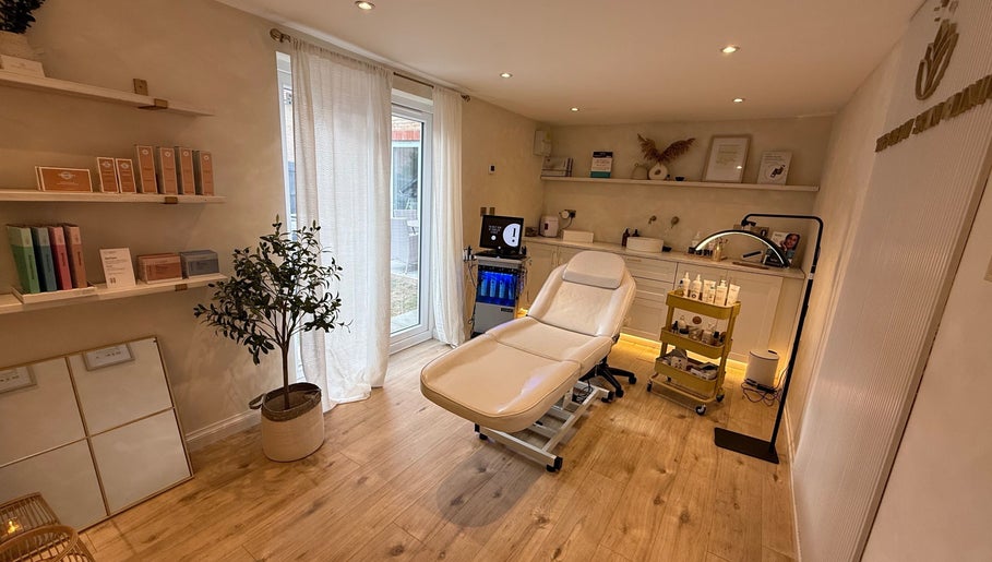 Relaxing treatment room at The Glow Skin Clinic in Caddington, Luton, England featuring modern decor and spa chair.