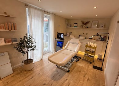 Relaxing treatment room at The Glow Skin Clinic in Caddington, Luton, England featuring modern decor and spa chair.
