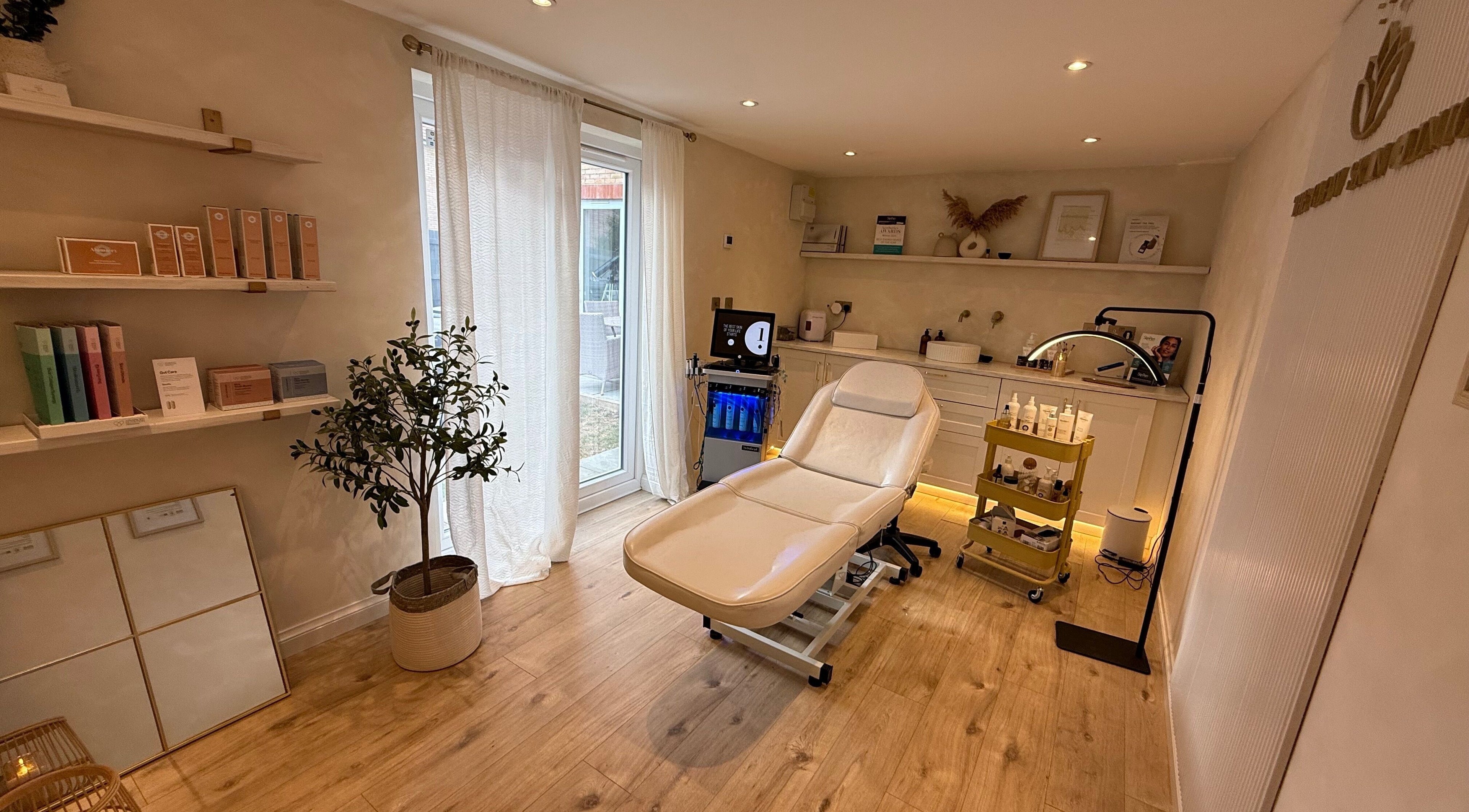 Relaxing treatment room at The Glow Skin Clinic in Caddington, Luton, England featuring modern decor and spa chair.