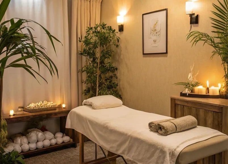Tranquil therapy room at NIHETSKN, Abuja, Federal Capital Territory, NG with candles, plants, and massage table.