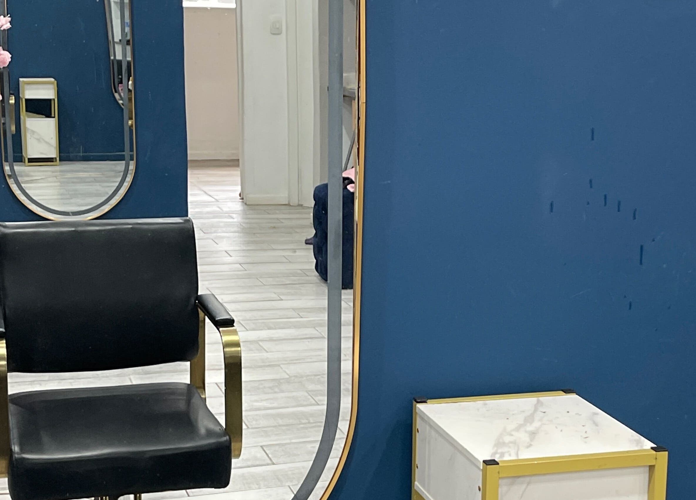 Modern salon chair in front of elegant mirrors at Milees Beauty Studio in Pretoria, Gauteng, ZA.