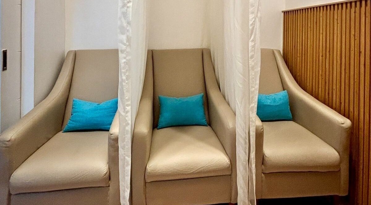 Elegant seating area at Skin Desyre Aesthetic Clinic - Cainta, Cainta, Calabarzon, PH with neutral armchairs.