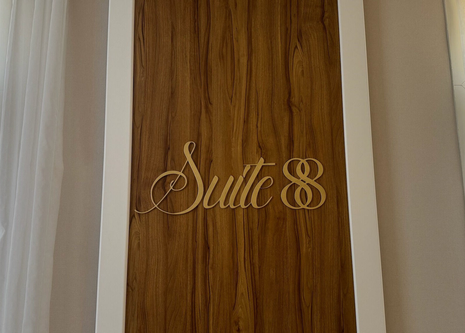 Suite 88 Beauty Lounge sign on a wooden wall in Sharjah, Sharjah, AE.
