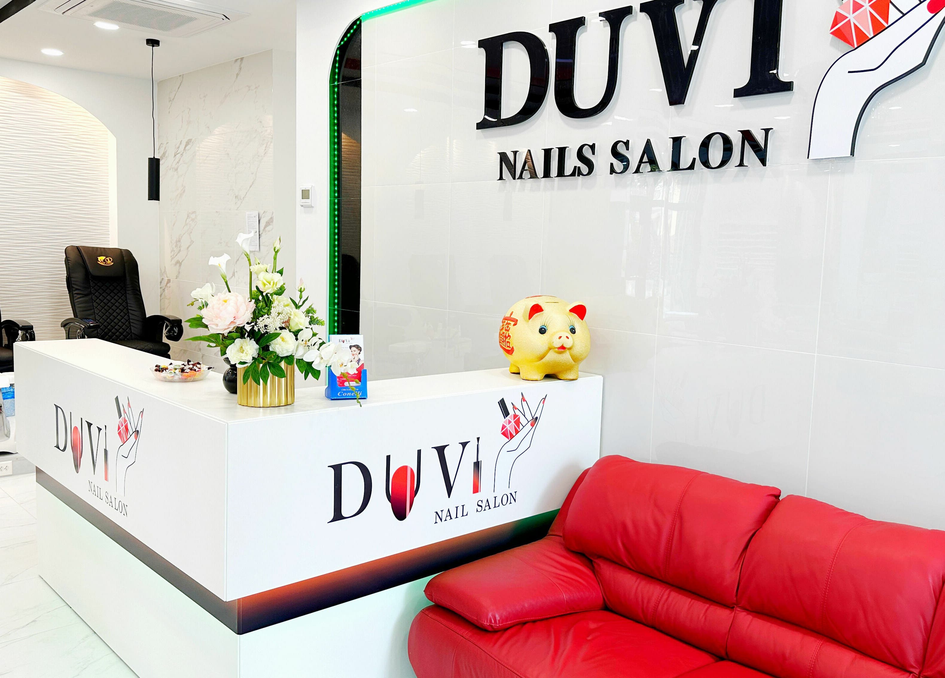 Reception area at DUVI Nails in Zürich, Zürich, CH, featuring a stylish red sofa and chic decor.