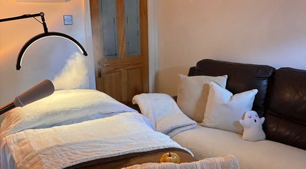 Tranquil therapy room at Home Therapy, Kidderminster, England, GB with massage bed and soothing atmosphere.