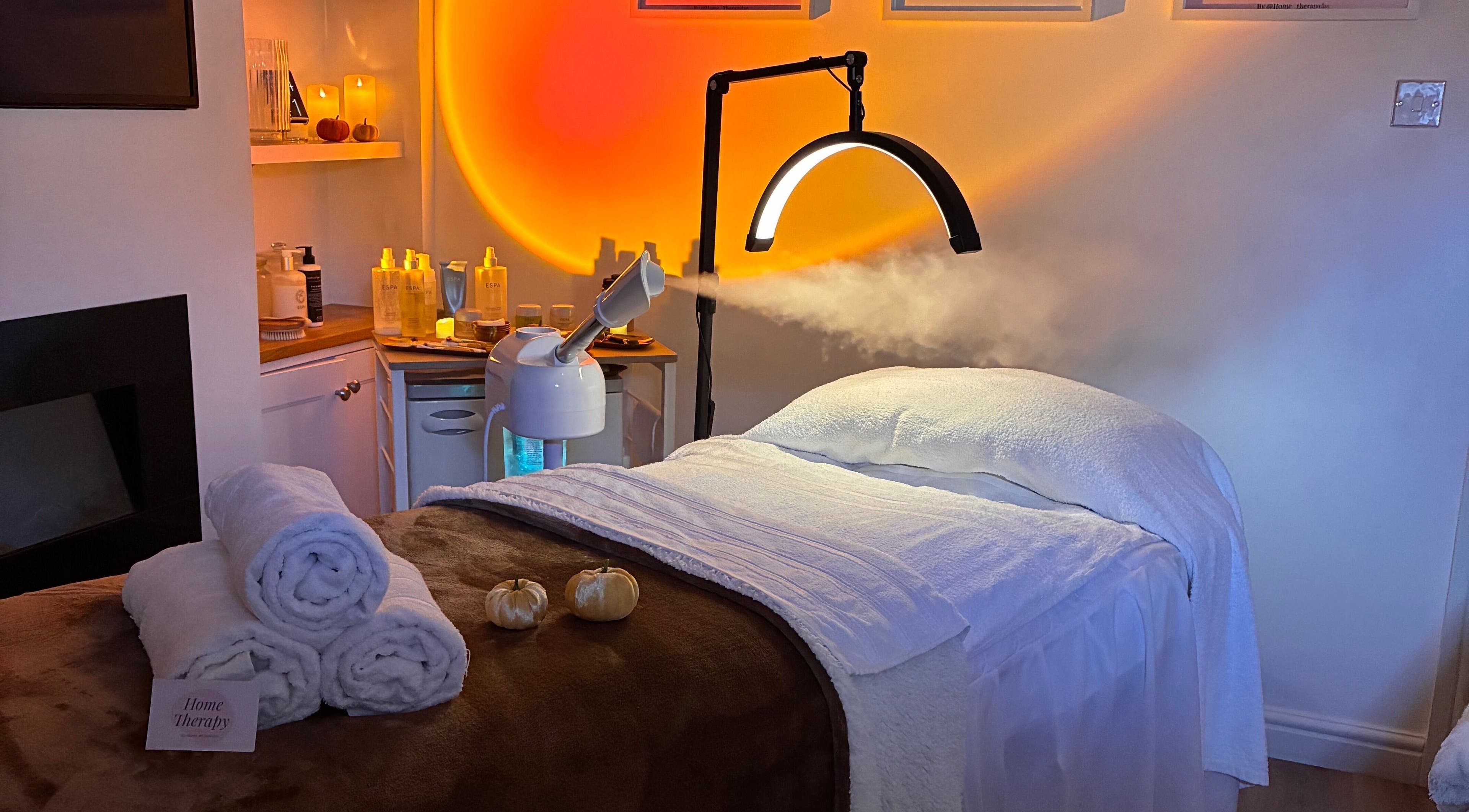 Relaxing treatment room at Home Therapy, Kidderminster, England, GB with warm lighting and spa bed.