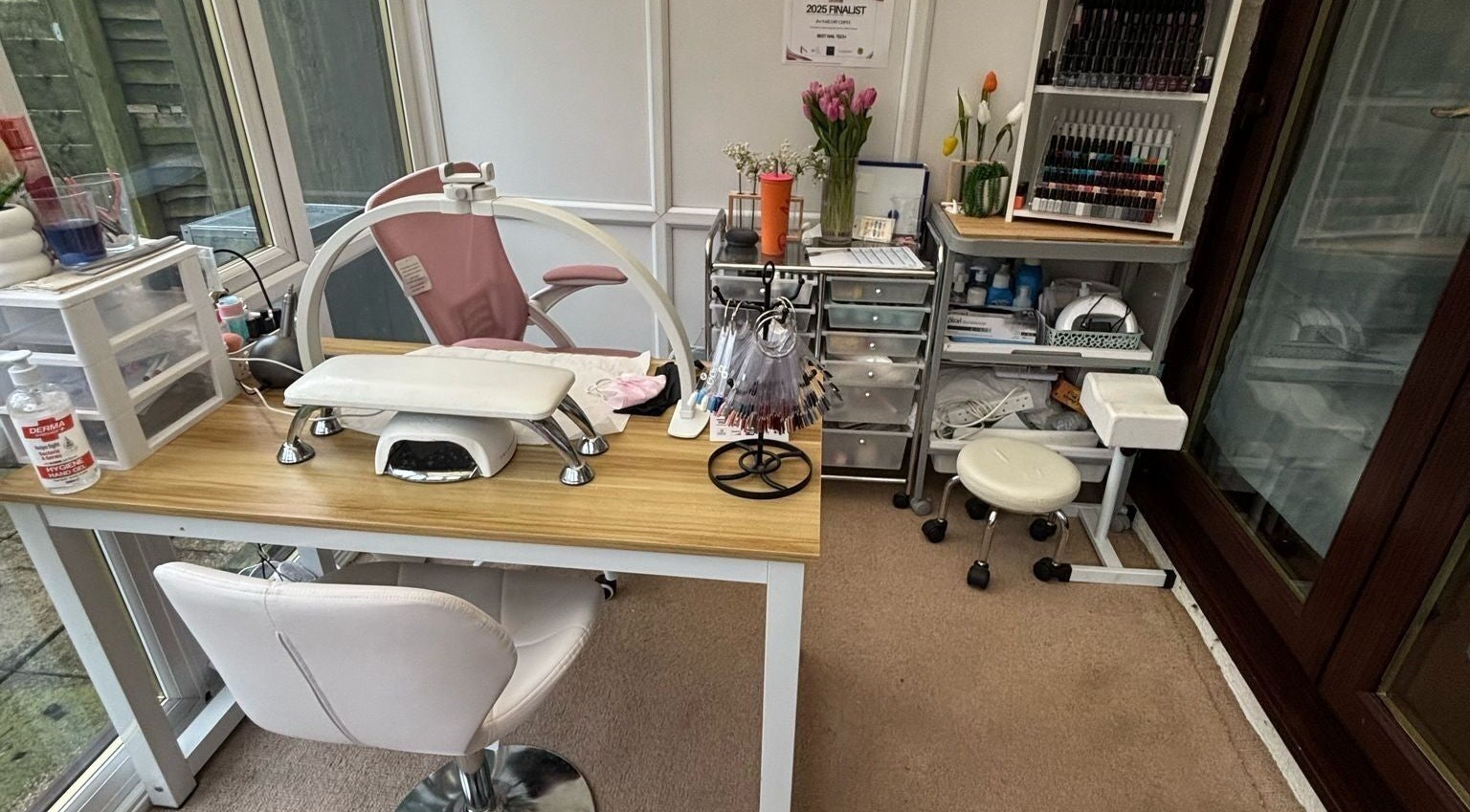 Cozy nail station at Da Nails By Cerys in Downswood, England, GB, featuring manicure tools and vibrant polish display.