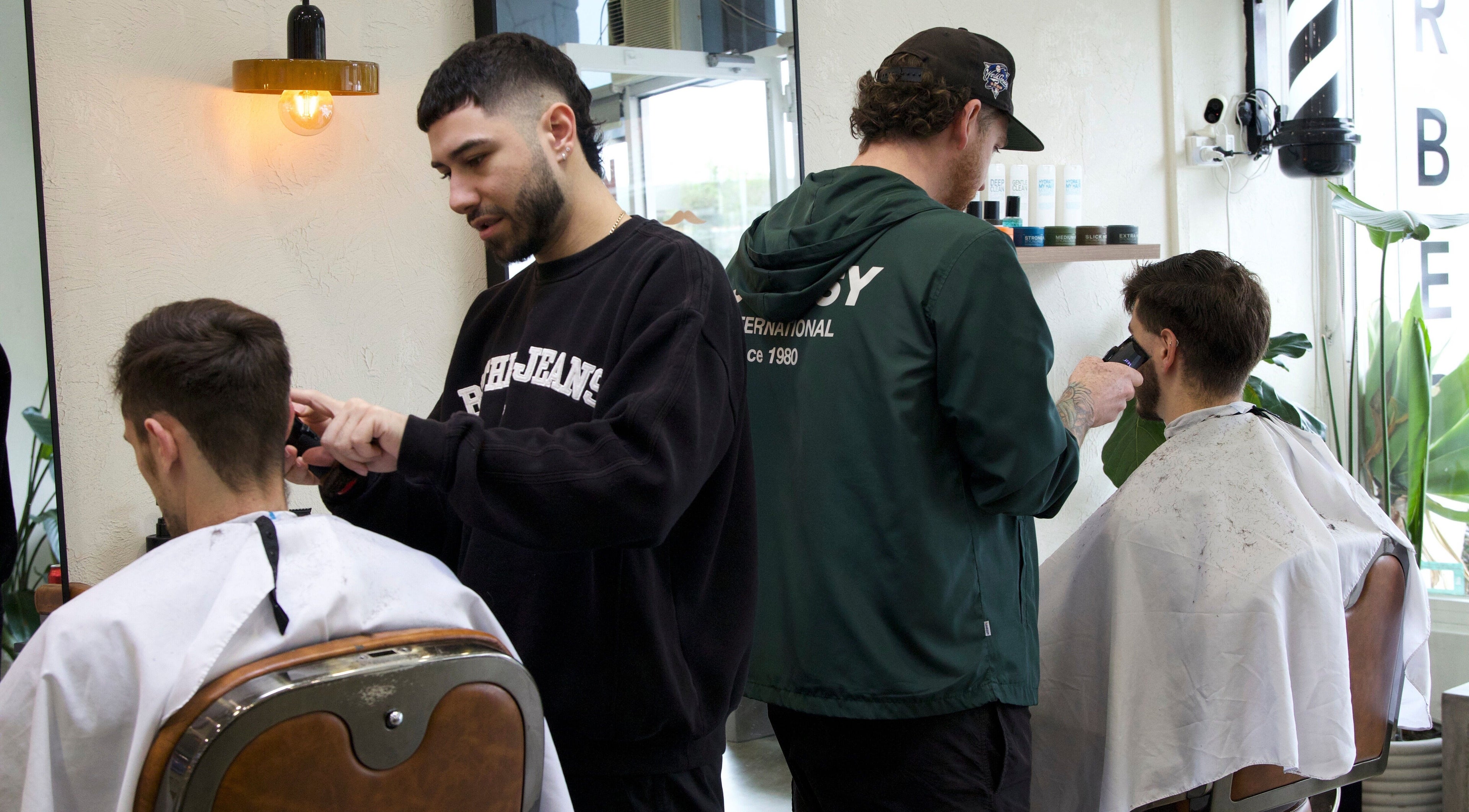 Barbers at Blck and Brwn Barber Shop in Melbourne, Victoria, AU delivering stylish haircuts to clients.