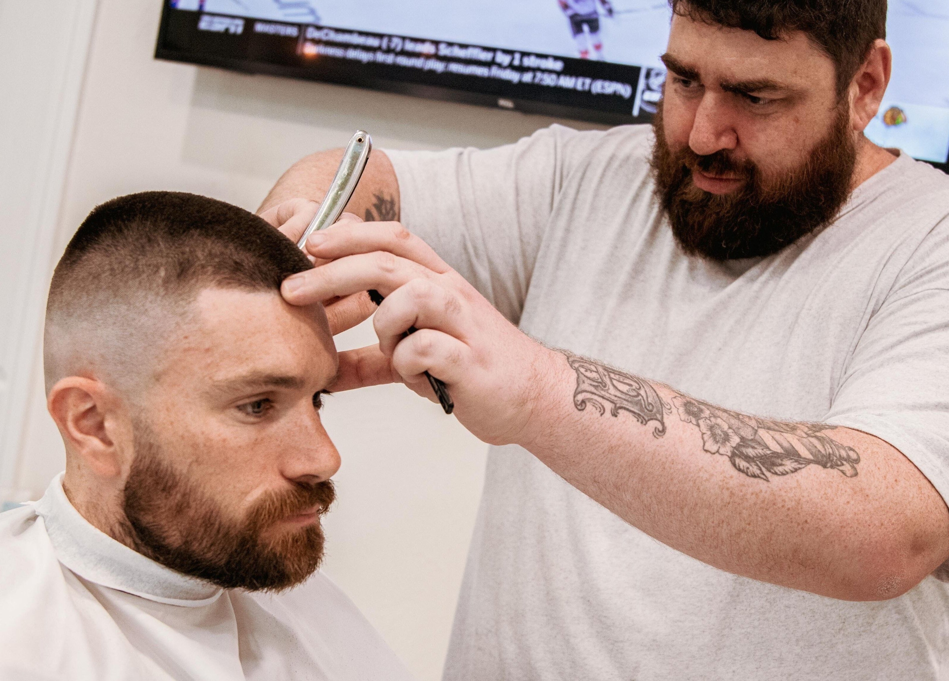 Professional barber giving a haircut at Blck and Brwn Barber Shop, Melbourne, Victoria, AU.