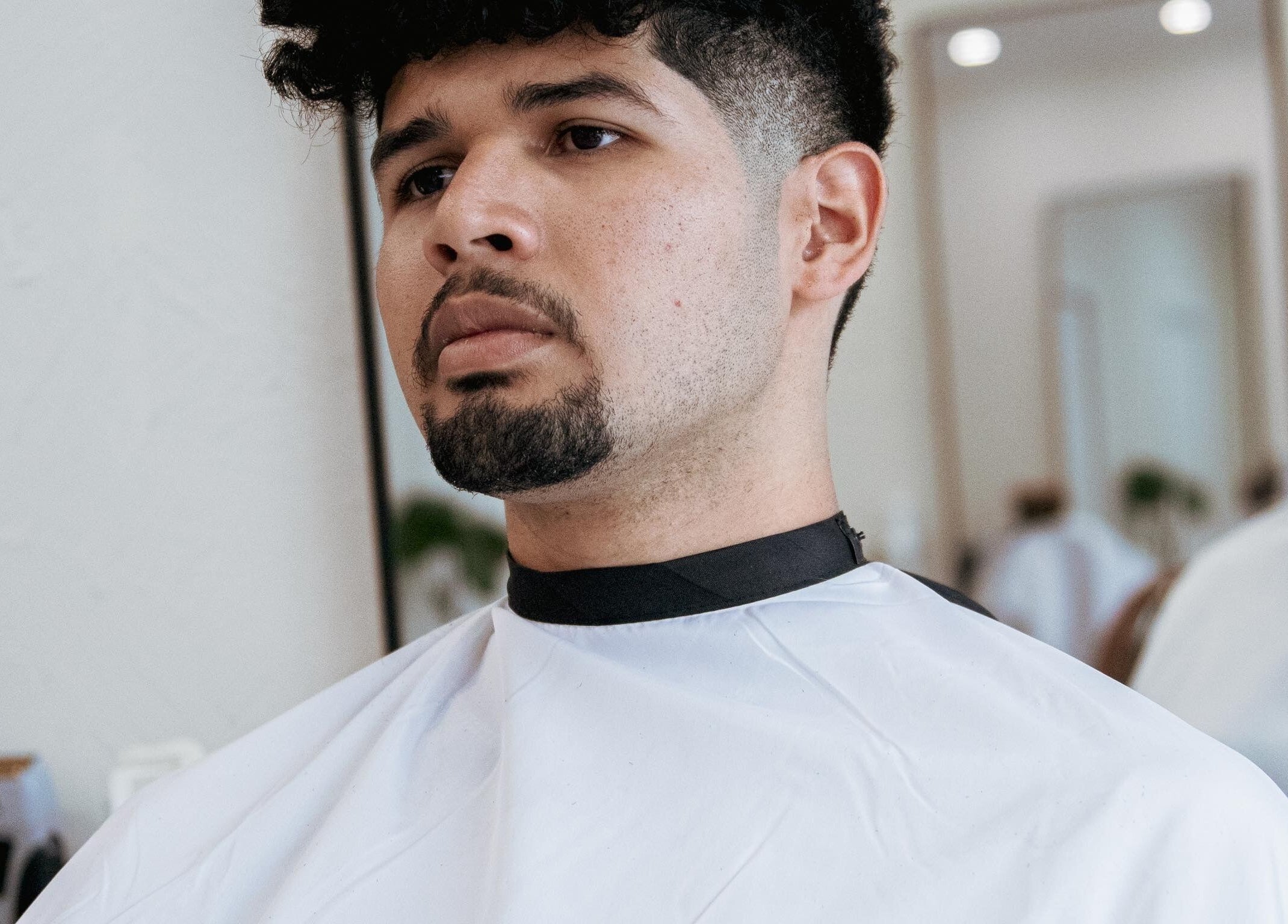 Client at Blck and Brwn Barber Shop, Melbourne, Victoria, AU, getting a trendy haircut with precision.