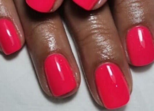 Bright pink manicured nails at La Bella's Hair and Beauty Salon, Cape Town, Western Cape, ZA.