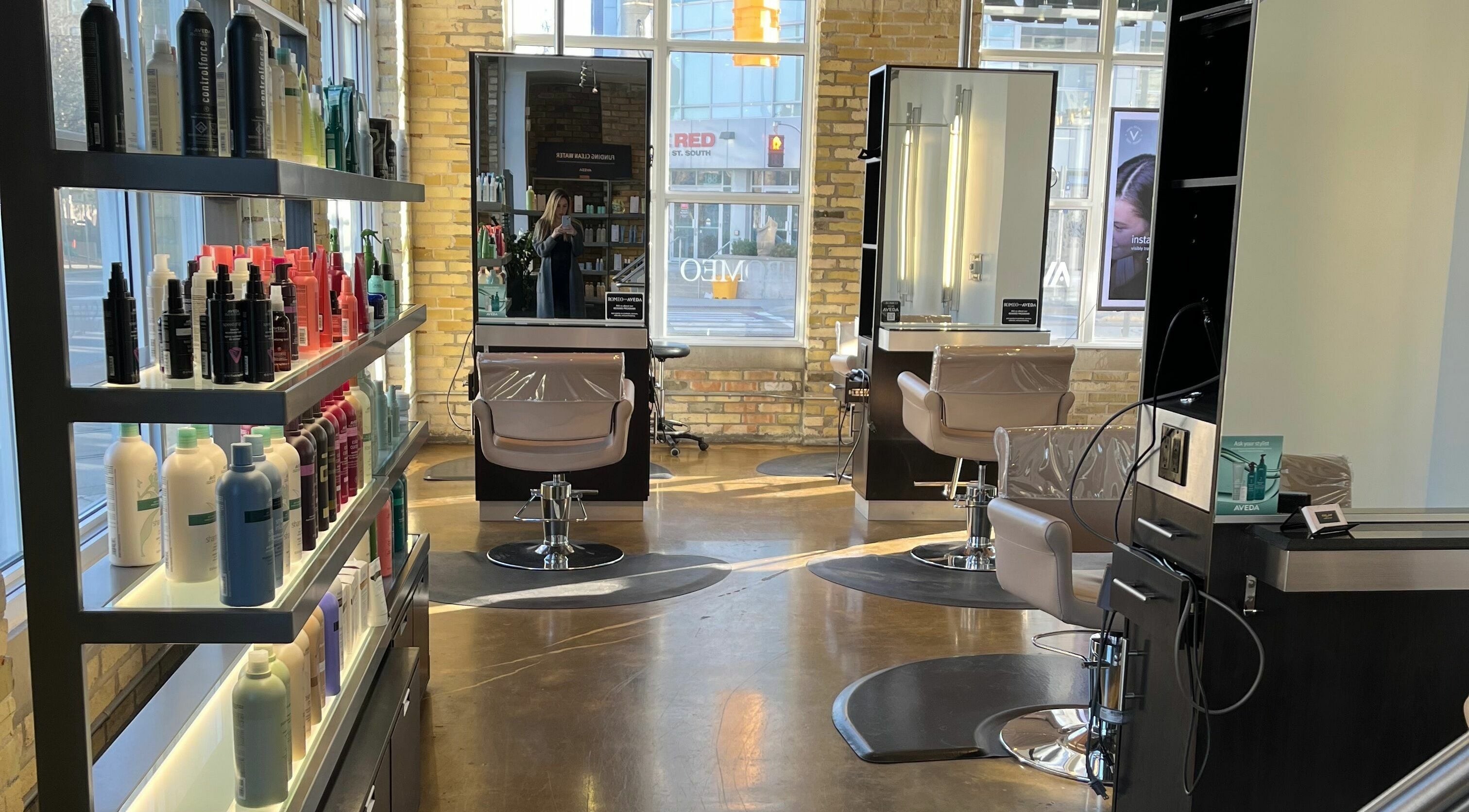 Modern interior of Romeo Salon Waterloo with stylish chairs and product shelves in Waterloo, Ontario, CA.