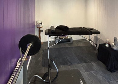 Tranquil massage room at Caitlin May Massage in Lichfield, England, GB with calming decor and fitness equipment.