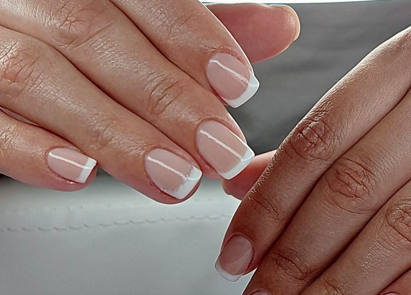 French manicured hands at LadyLuxe Salon, Linz, Oberösterreich, AT showcasing elegance.