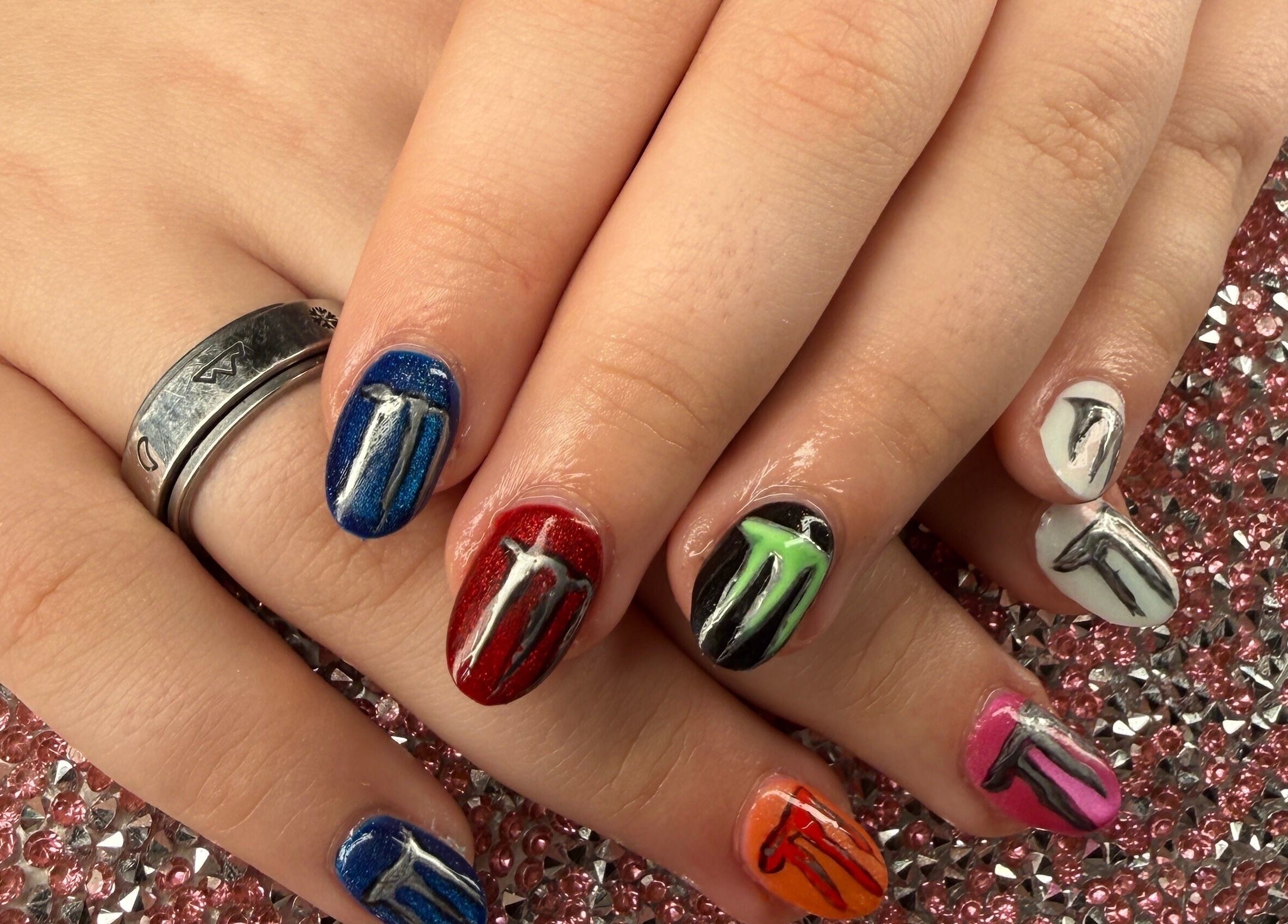 Colorful nail art at Rook and Raven Nail Co., Saltsburg, Pennsylvania, US on sparkling background.