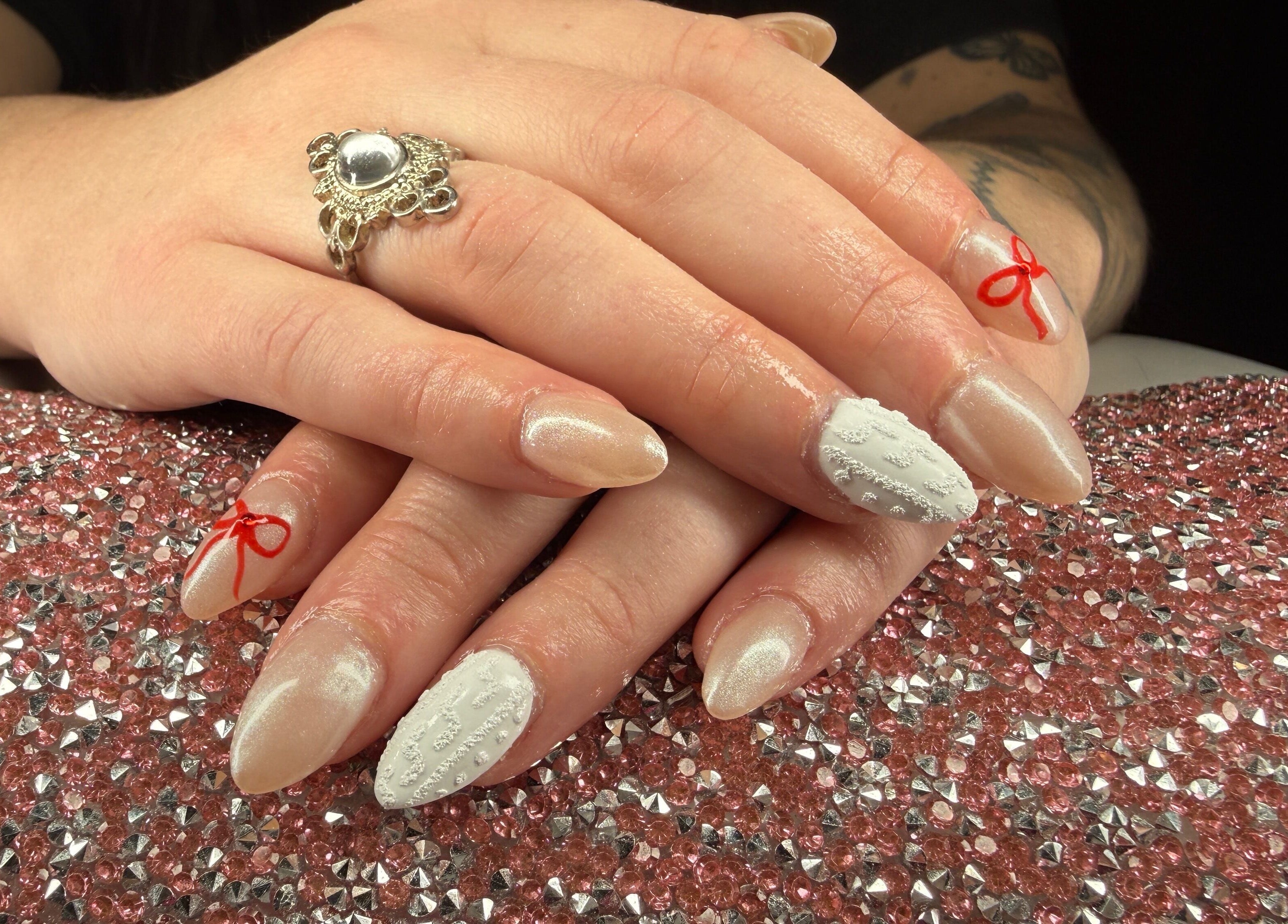 Beautifully manicured nails with red ribbons at Rook and Raven Nail Co. in Saltsburg, Pennsylvania, US.