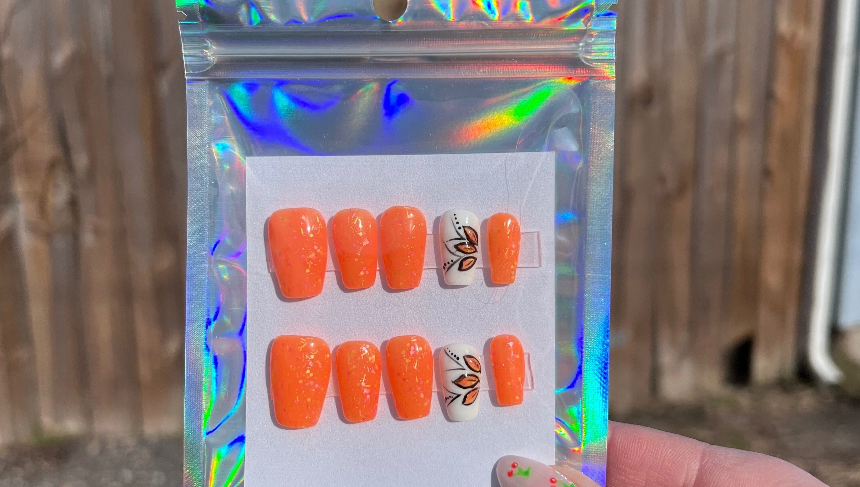 Orange and white nail set with leaf design from Rook and Raven Nail Co., Saltsburg, Pennsylvania, US.