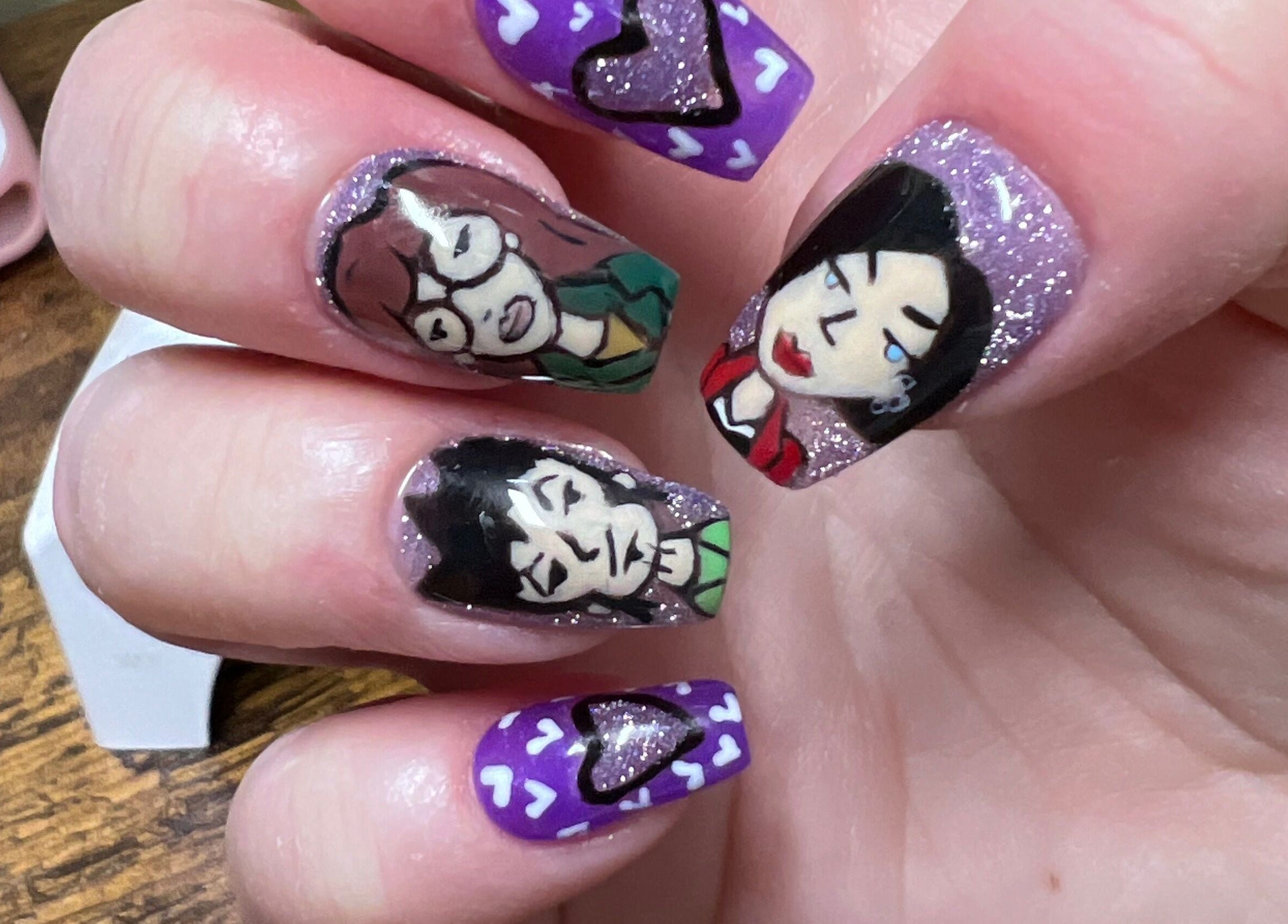 Unique hand-painted nail art at Rook and Raven Nail Co., Saltsburg, Pennsylvania, US featuring abstract faces.