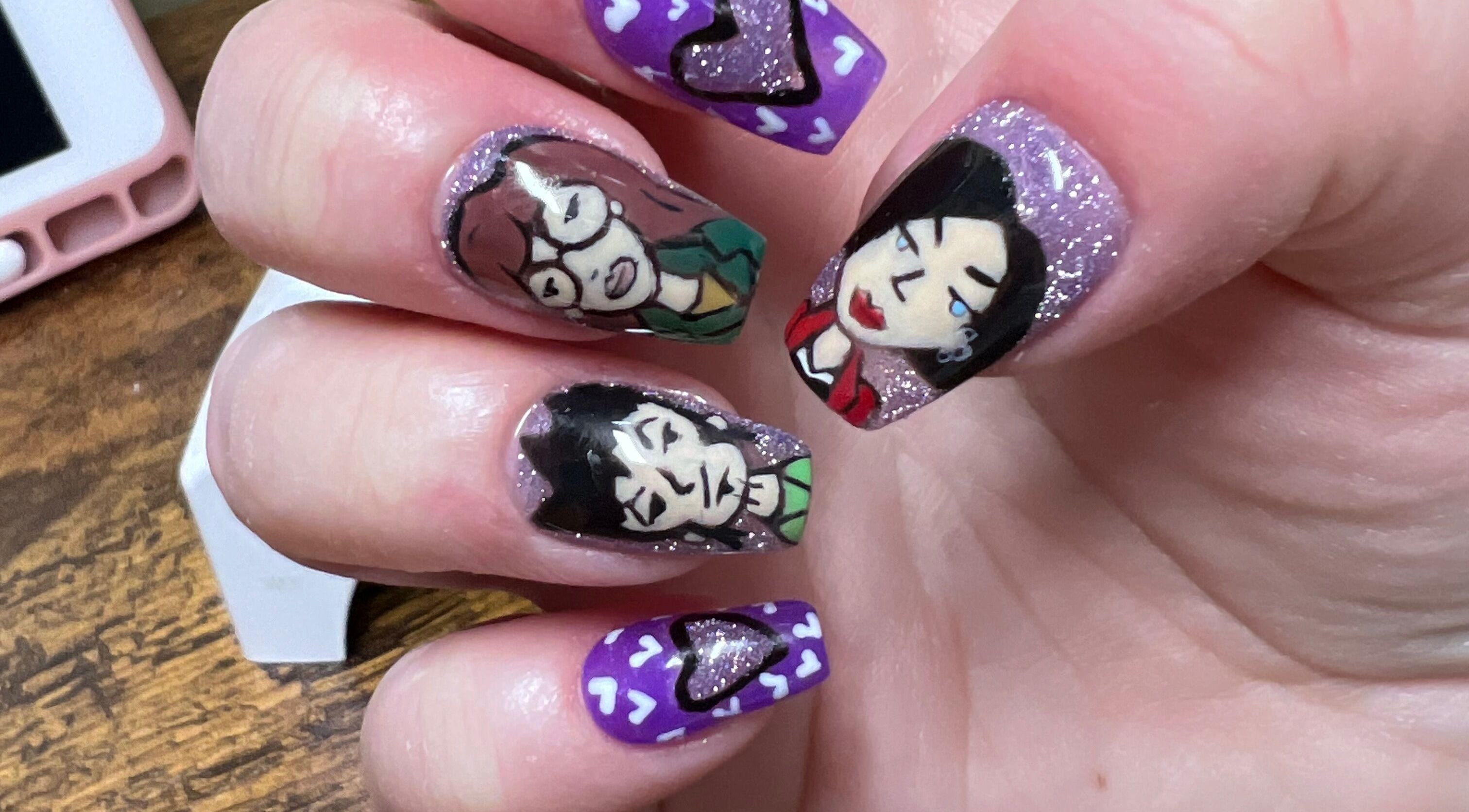 Unique hand-painted nail art at Rook and Raven Nail Co., Saltsburg, Pennsylvania, US featuring abstract faces.