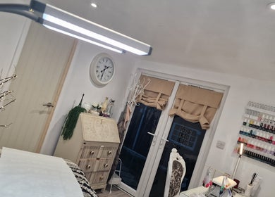 Elegant interior of J'adore Beauty Rooms, Normanton, England, GB with nail polish display and cozy decor.