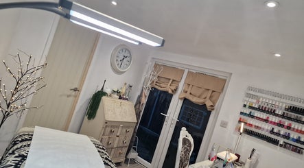 Elegant interior of J'adore Beauty Rooms, Normanton, England, GB with nail polish display and cozy decor.